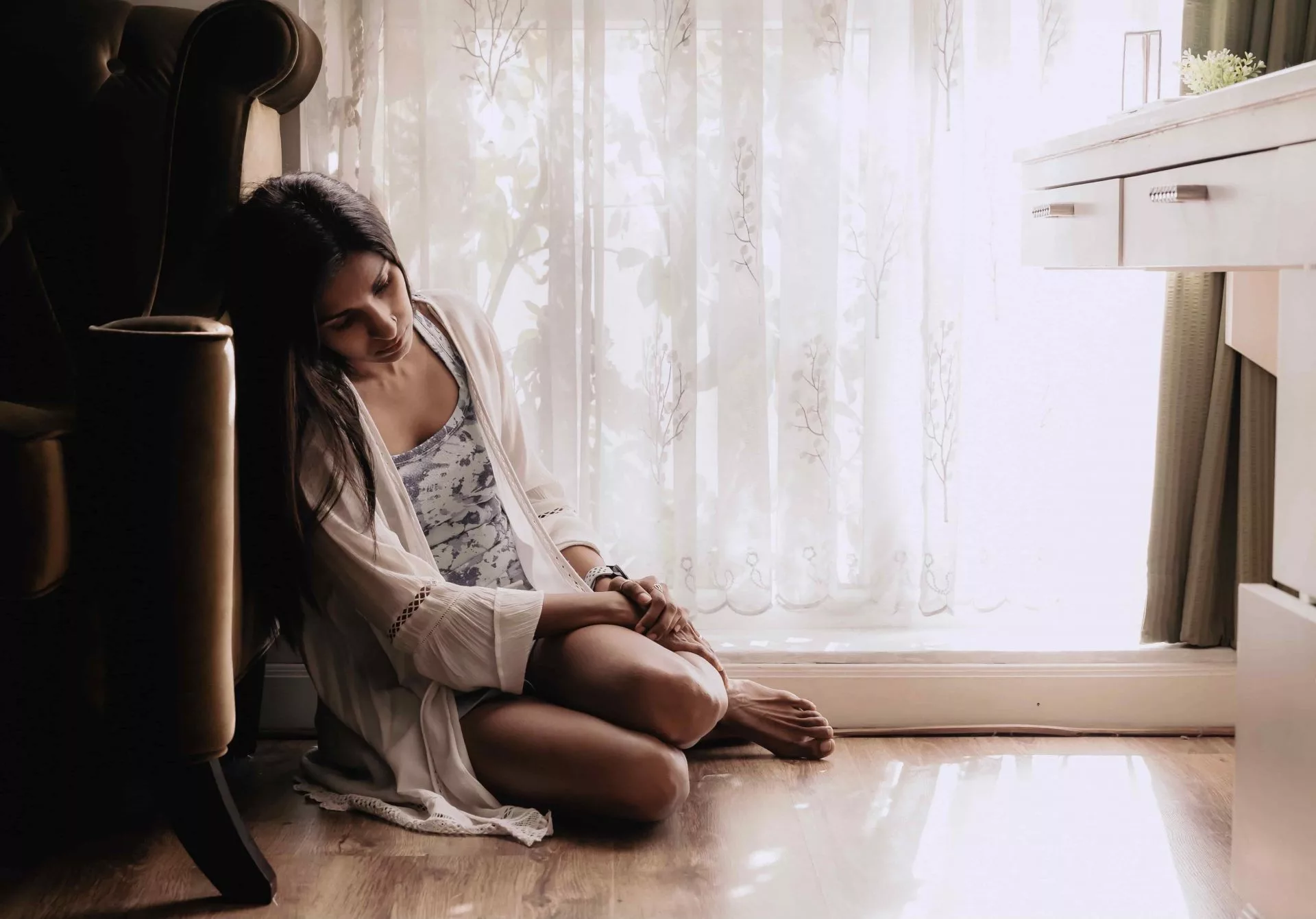 woman sitting on the floor in distress