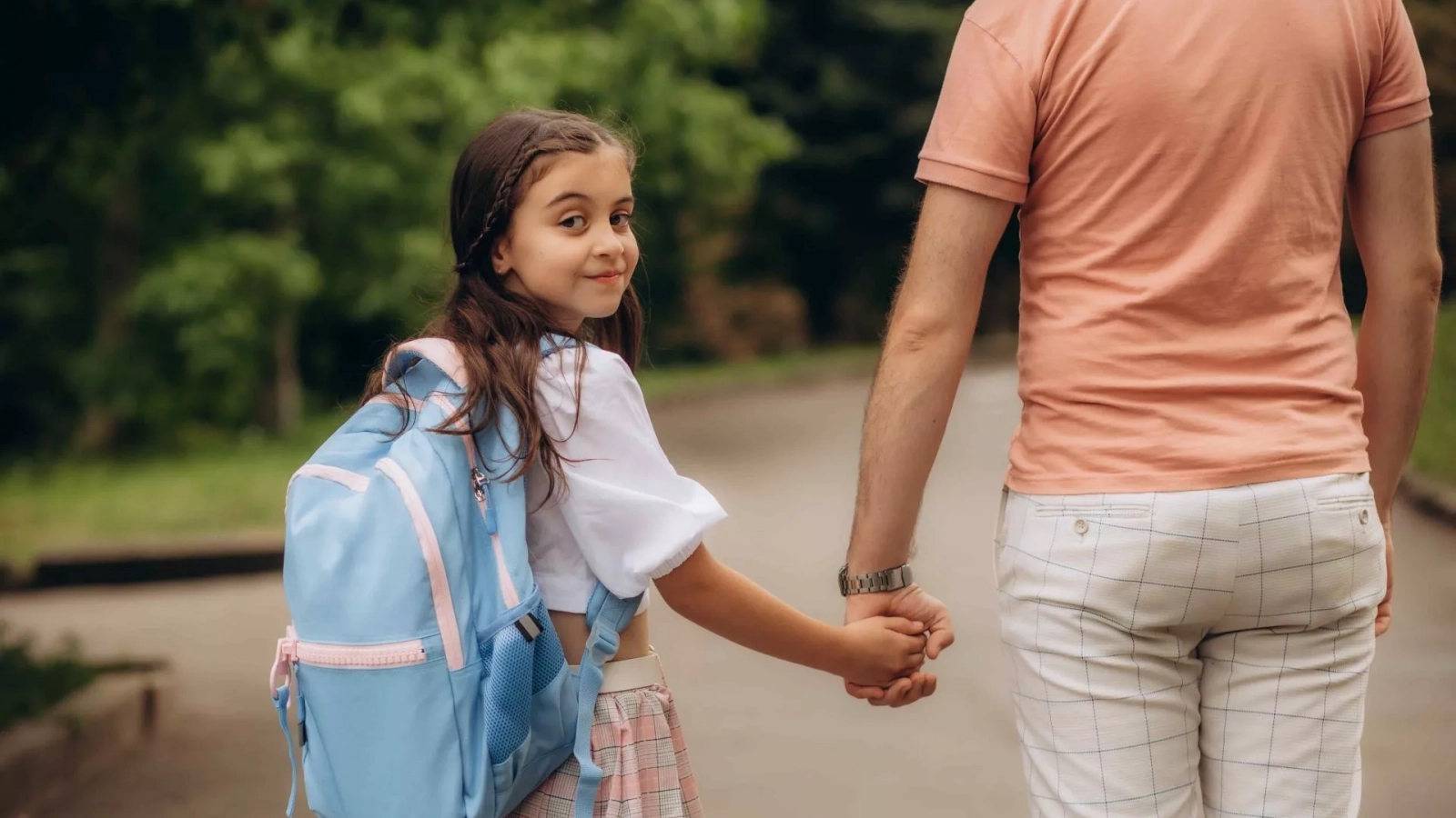 Child returning to school after holidays with support from separated parents
