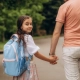 Child returning to school after holidays with support from separated parents