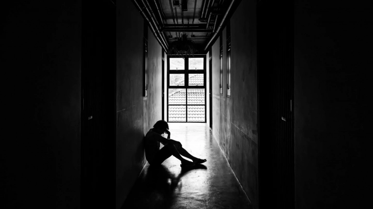 lonely man sitting in hallway needingan occupation order