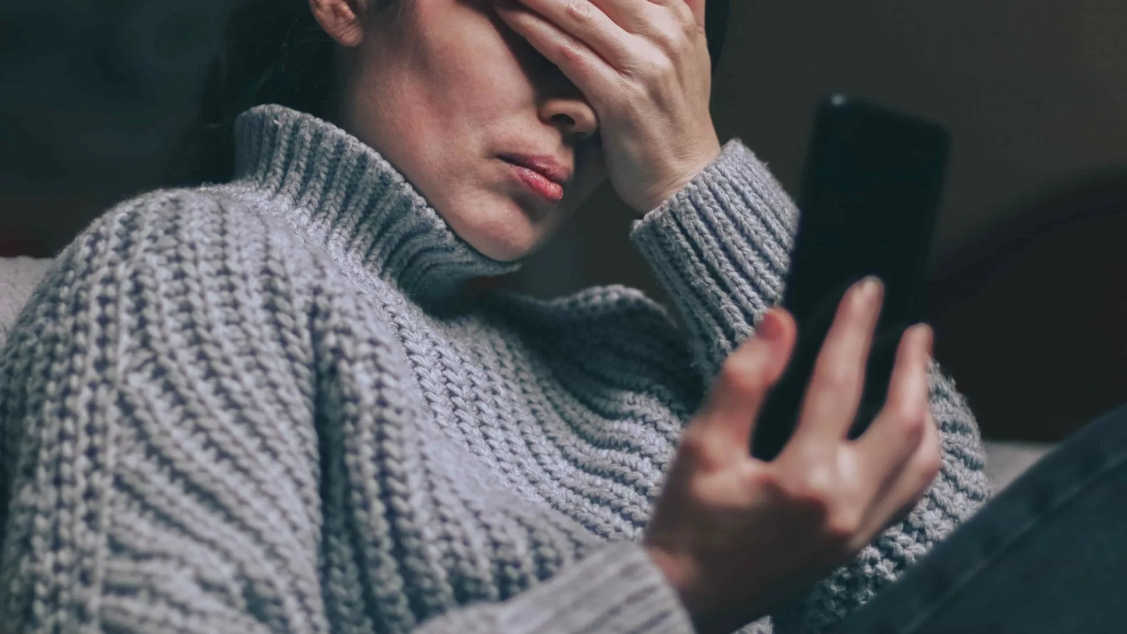 Person reading a message on their phone, trying not to respond emotionally